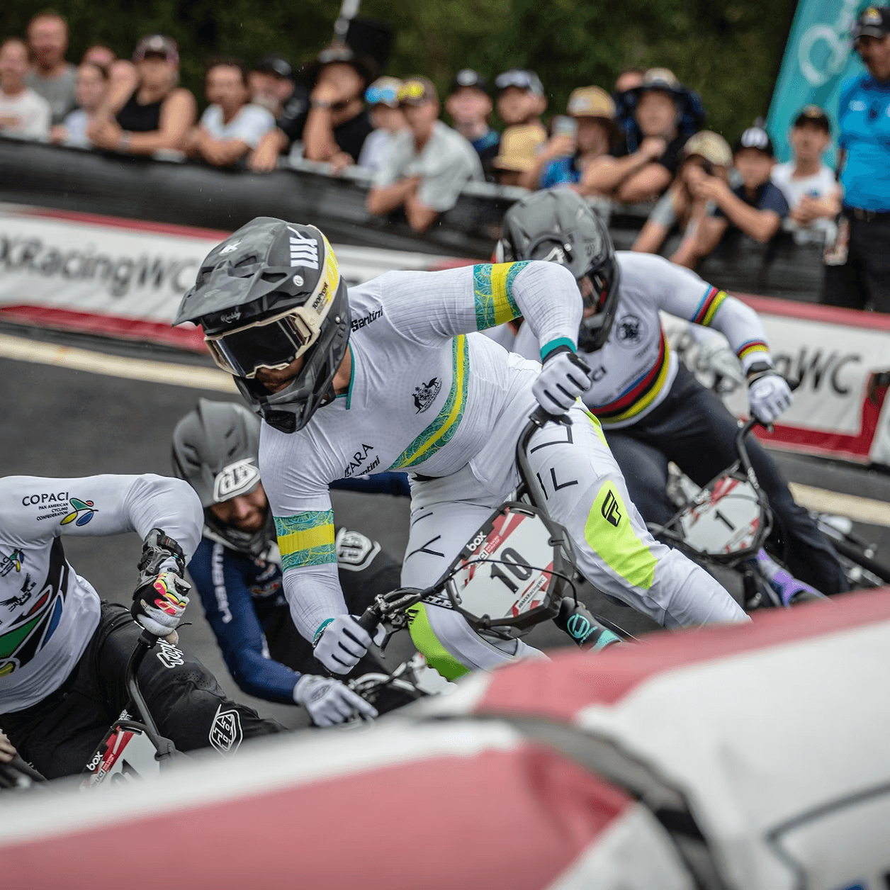 BMX racers at the starting gate with crowd